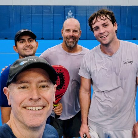 No better way to start the week! Four happy and exhausted padel players gather for a group photo on a court post-match